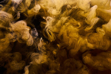 Liquid fluid art abstract background. Ocher jets and smoke rings dancing acrylic paints underwater,...