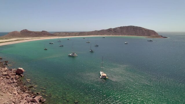 Aerial view of the luxurious sailboats and yachts on the sea on the coast in 4K