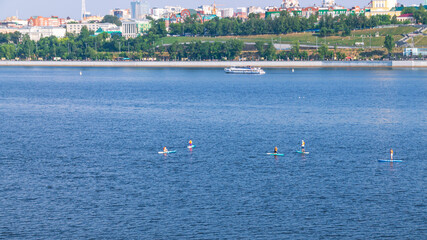 Active recreation on the board on the big river. Tourism on sap boards. Outdoor water sports....