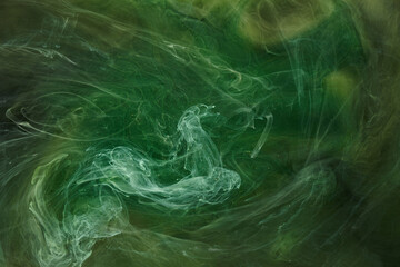 Liquid fluid art abstract background. Green dancing acrylic paints underwater, cosmic smoke ocean