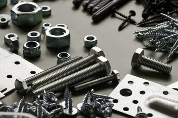 Set of bolts nuts nails metal fasteners. Consumable hardware tools. assortment steel screws collection close up background