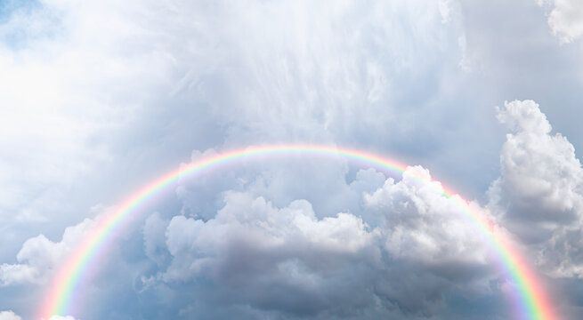 Amazing rainbow in the stormy sky after the rain with lighting flare