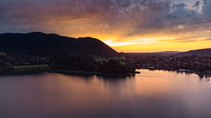 Fototapeta na wymiar Schliersee lake in south Germany in the Alps with magical colorful sunset from drone view