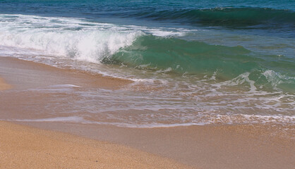 Clear emerald green sea with clean sandy beach