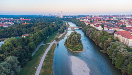 Isar river flowing through the city of Munich in a calm summer morning aerial image
