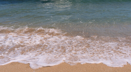 Clear emerald green sea with clean sandy beach