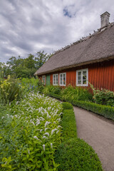 Old farm house with flower rich garden, a sunny summer day in Stockholm