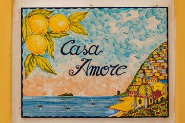 Ceramic background. Italian traditional patterns on tiles, handmade craft painting - house of love, landscape of Positano, lemons and the sea. Amalfi coast.