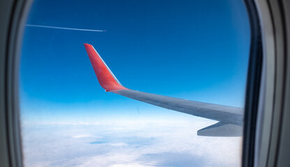 View of the wing and the plane flying parallel to the course from the porthole.