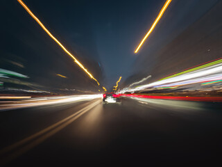 Beautiful shot of a speedy night drive on the highway. Front view from the car window to the road,...