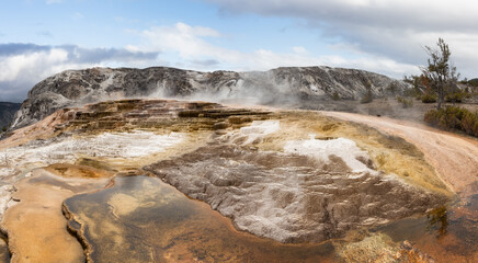 Hot spring Geyser with colorful water in American Landscape. Cloudy Sky Art Render. Yellowstone National Park, Wyoming, United States. Nature Background Panorama