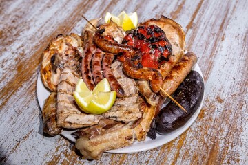Top-view of roasted meat and sausages assorted on the table
