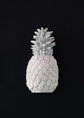 An aesthetic arrangement made of gray pineapple on a black background. Minimal flat lay concept. Retro summer inspiration.
