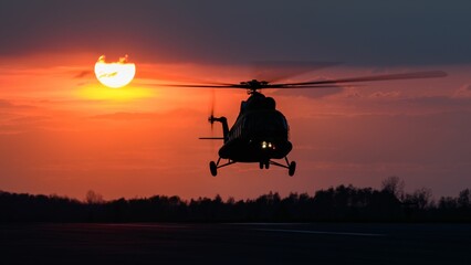 Beautiful shot of  Polish Army helicopter Mi-8 during training flights in colorful sunset sky
