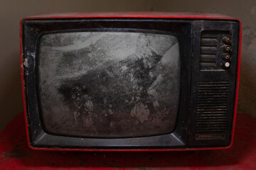 Old broken and dirty analogue television