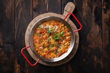 Menemen on wooden background , Turkish breakfast, top view