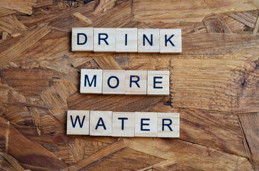 drink more water text on wooden square, health quotes