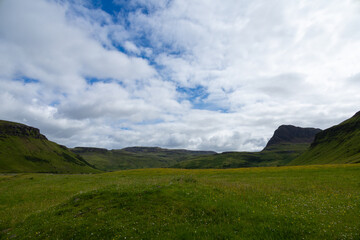 Wide angle views of Talisker Bay, Isle of Skye, Scotland, with its rocky beach, black stones, green...