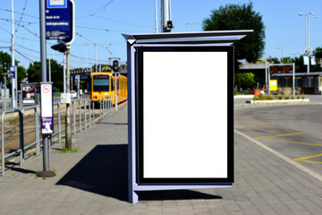 image composite of bus shelter at bus stop of blank light box and glass structure. green street...