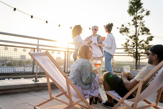 Young couple chilling together at the rooftop party - Powered by Adobe