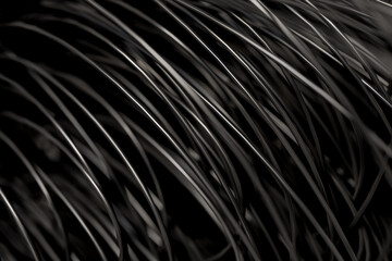 Background with black wires in soft focus. Dark template on the theme of high technology and power grids with rubber cords.