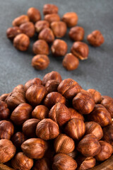 Top view of a bowl full of hazelnuts on dark background
