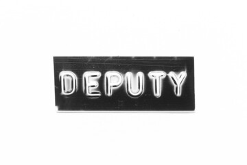 Black color banner that have embossed letter with word deputy on white paper background