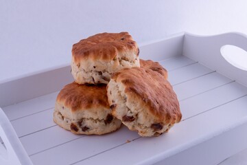 British food, delicious fruit scones isolated on white tray