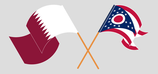 Crossed and waving flags of Qatar and the State of Ohio