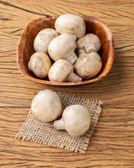 Paris mushrooms in a bowl over wooden table