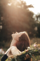 Happy woman enjoying the life in the sunny field