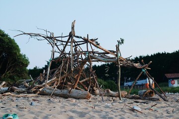 Fun shelter on the beach made of branches