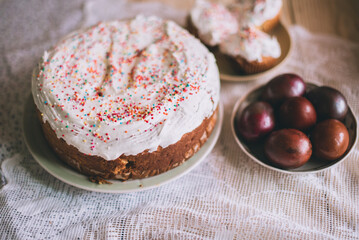 Easter table with traditional Easter cakes and Easter eggs with blossoming tree branch