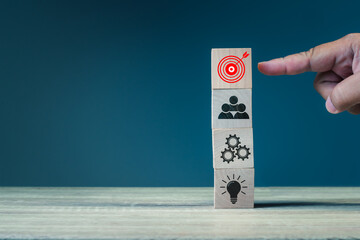 Concept of business strategy and action plan. stack wood cube block, Hand point goal and target, teamwork business development management concept
