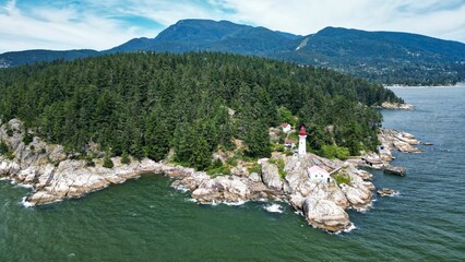 View of an old lighthouse on the tree covered seashore