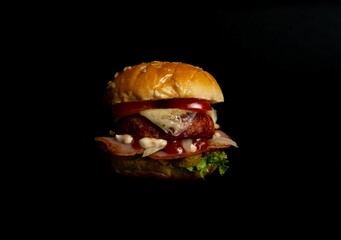 Closeup of mini burger isolated in black background