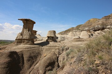 Landscape with the stones of hoodoos with stratas (the Badlands) under the blue sky, Alberta, Canada