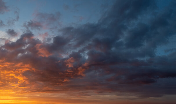 dramatic sunset with clouds in the sky down to the horizon lone