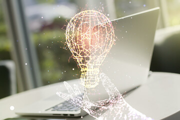 Double exposure of creative light bulb hologram on laptop background, research and development concept