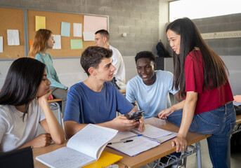 Group of multi-ethnic students talking in class during a break. High school, back to school, diverse students - Powered by Adobe