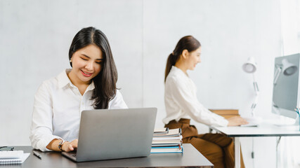 Young Asian Attractive business woman working with friends or colleagues in business office workplace.