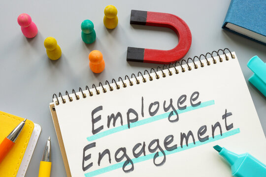 Phrase employee engagement near magnet and figurines.