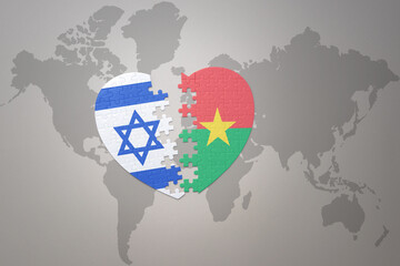 puzzle heart with the national flag of burkina faso and israel on a world map background.Concept.