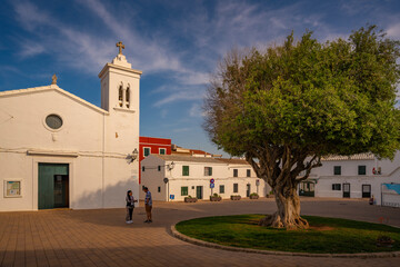 View of Sant Antoni de Fornells church in whitewashed street in Fornelles, Fornelles, Menorca, Balearic Islands, Spain