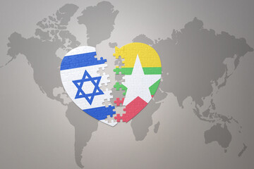 puzzle heart with the national flag of myanmar and israel on a world map background.Concept.