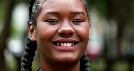 Mixed race black girl laughing outdoors looking at camera