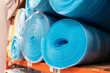 polypropylene or other foamed synthetic material rolled up on the shelf of a construction store