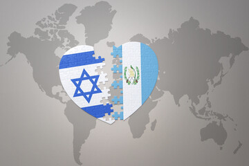 puzzle heart with the national flag of guatemala and israel on a world map background.Concept.