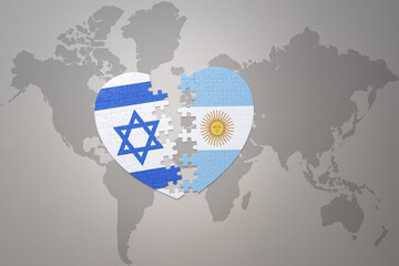 puzzle heart with the national flag of argentina and israel on a world map background.Concept.