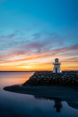 Vertical shot of glorious landscape, sunset in Arisaig Lighthouse in Nova Scotia, Canada.